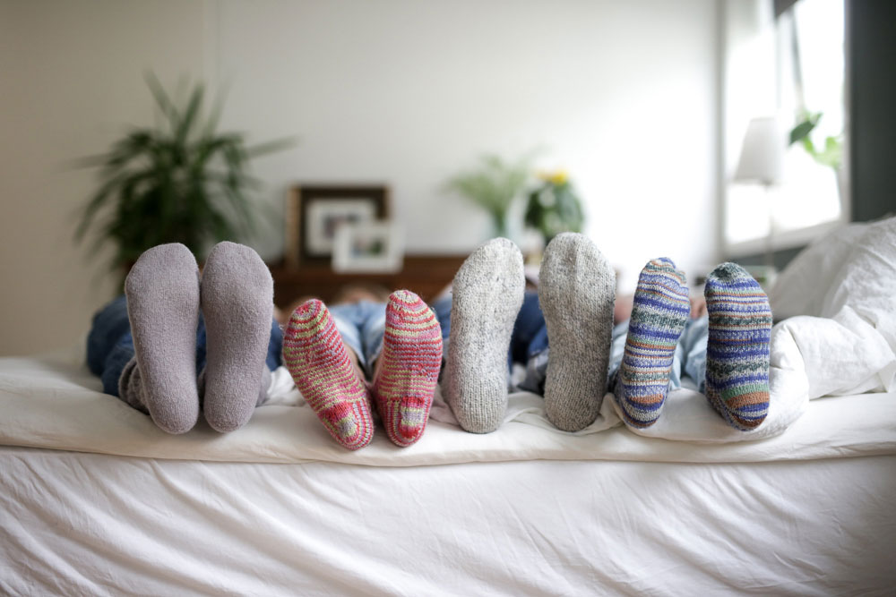 Føtter med raggsokker over sofakanten